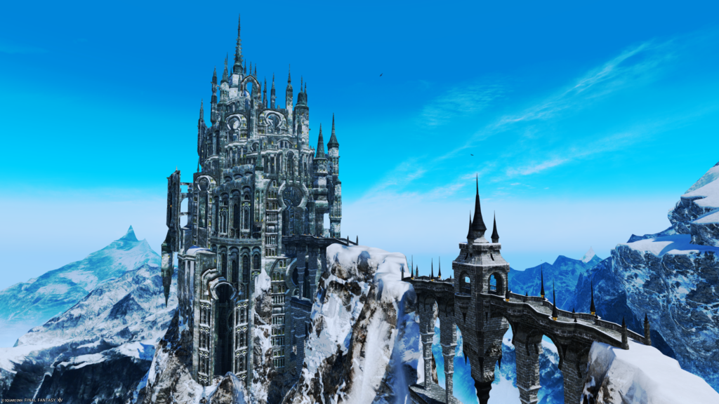 A screenshot from the video game FFXIV. This screenshot depicts a giant stone city jutting against a blue sky with mountains in the dstance, and a stone bridge connecting it.